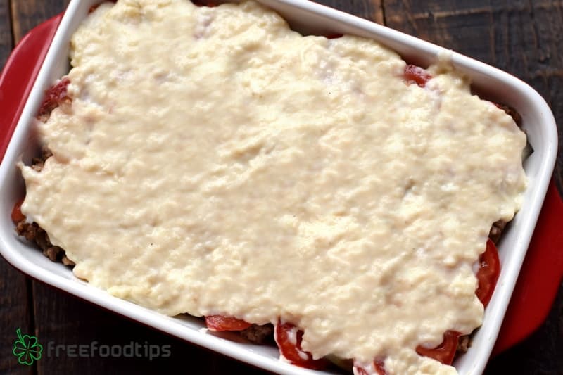 Spread béchamel sauce evenly over tomatoes